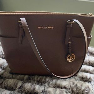 Michael Kors light brown purse.